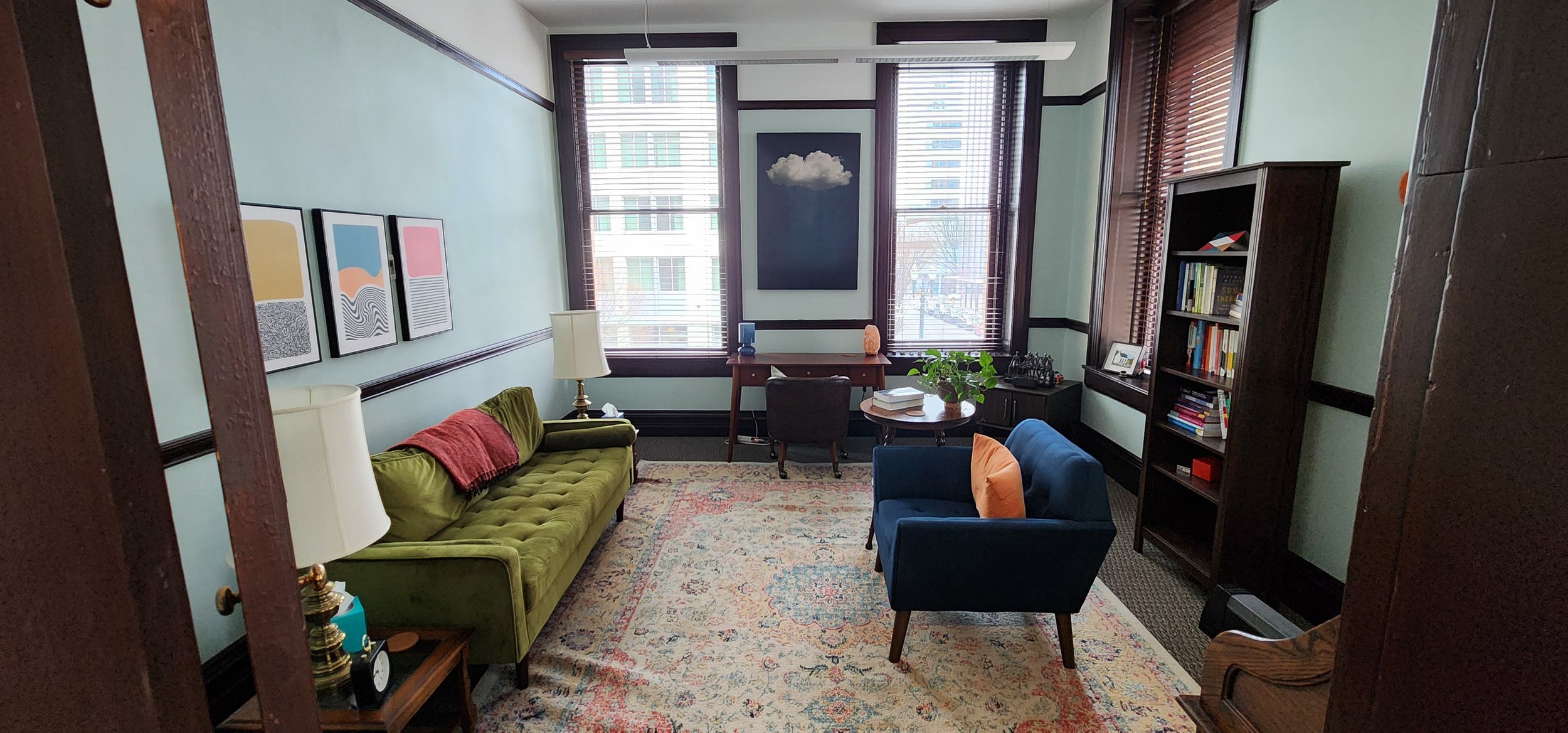 A private therapy office with seating and natural light